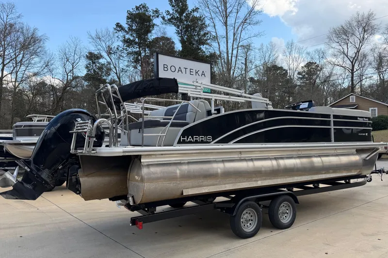 Slide: The Image of 2024 Harris Cruiser 230 pontoon boat on trailer at Boateka dealership. - 2