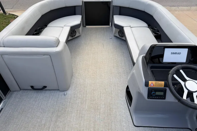 Slide: The Image of 2024 Harris Cruiser 230 interior with gray seating and modern steering console. - 3