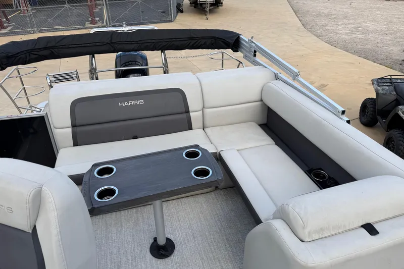 Slide: The Image of 2024 Harris Cruiser 230 pontoon boat interior with plush seating and cupholders. - 7