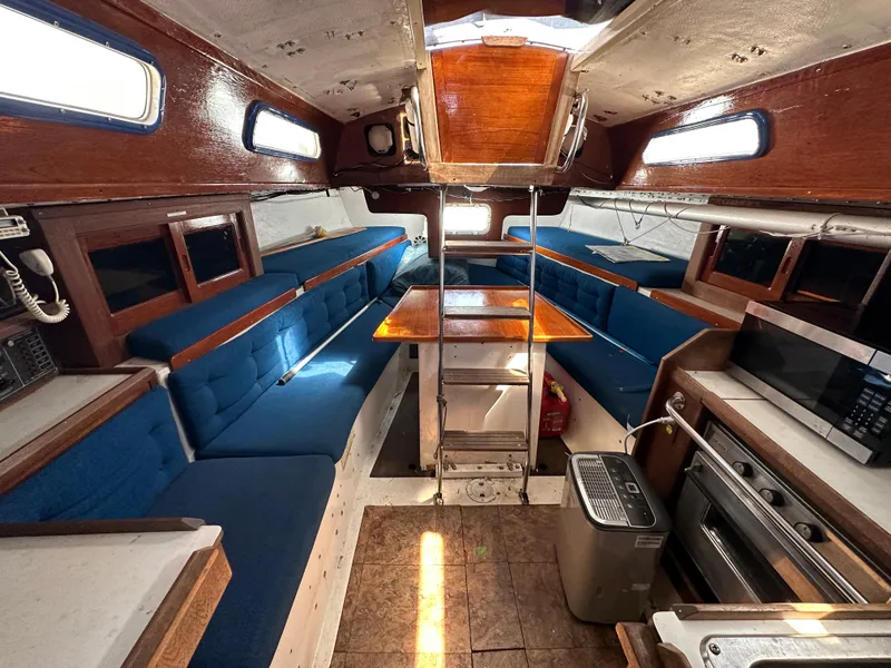 Slide: The Image of Interior of a 1982 Schock NY 36 yacht with blue upholstery. - 12