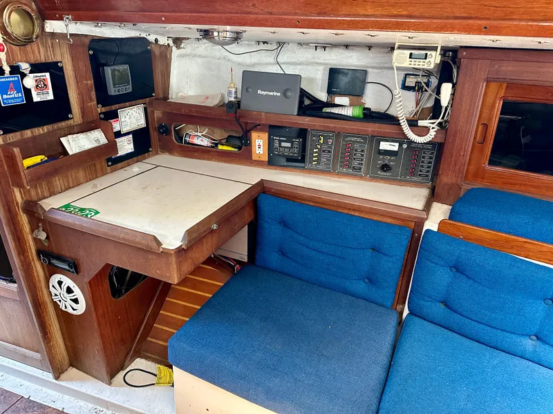 Slide: The Image of Interior of a 1982 Schock NY 36 yacht with blue seating. - 13