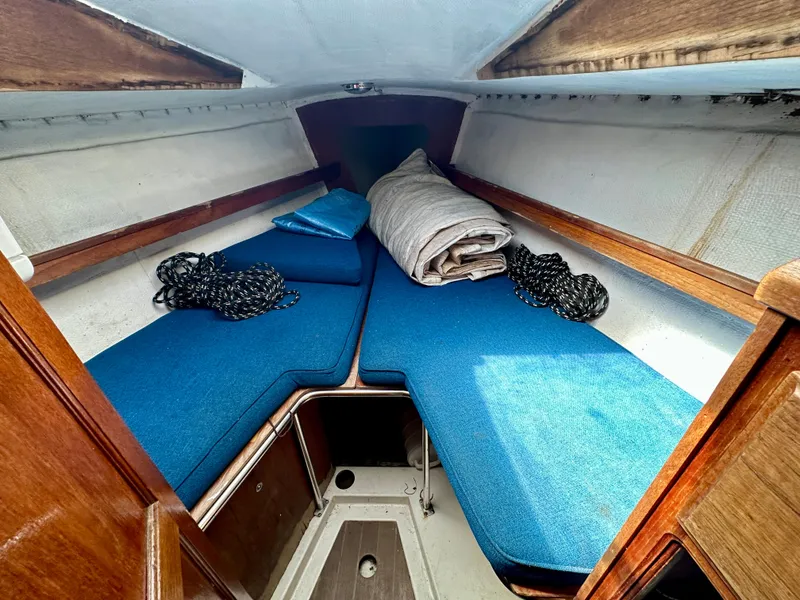 Slide: The Image of Interior of a 1982 Schock NY 36 yacht with blue cushions. - 17