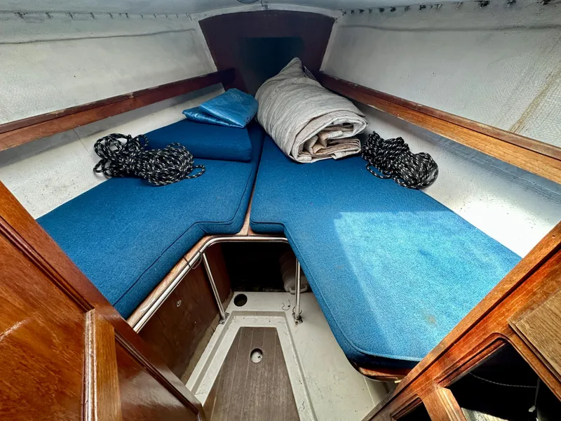 Slide: The Image of Interior of a 1982 Schock NY 36 yacht with blue cushions. - 18