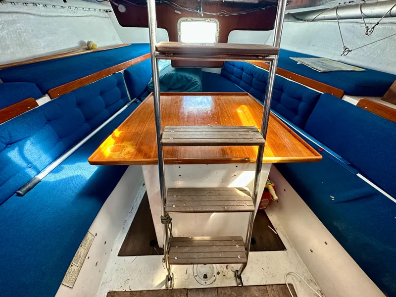 Slide: The Image of Interior of a 1982 Schock NY 36 yacht with blue seating. - 19