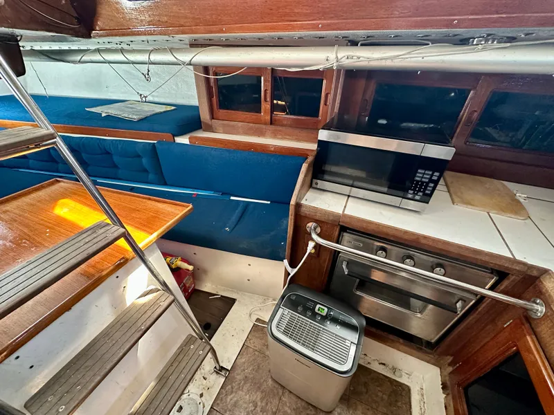 Slide: The Image of Interior of a 1982 Schock NY 36 yacht with kitchen and seating area. - 20