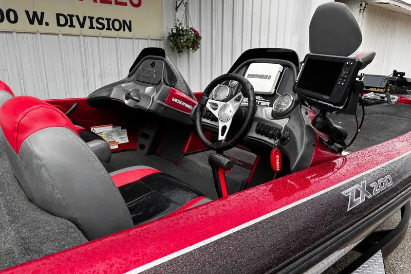 Slide: The Image of 2012 Skeeter ZX200 boat interior with red and black seats, gray carpet. - 12