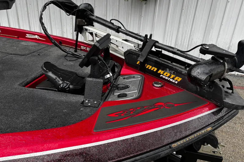 Slide: The Image of 2012 Skeeter ZX200 boat dashboard with steering wheel, Humminbird display, and Lowrance fishfinder. - 13