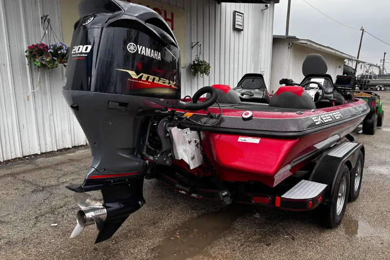 Slide: The Image of 2012 Skeeter ZX200 boat interior with red and black seats, steering wheel, and Humminbird display. - 15