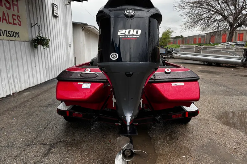 Slide: The Image of 2012 Skeeter ZX200 boat interior with red and gray seating and fishing equipment. - 16