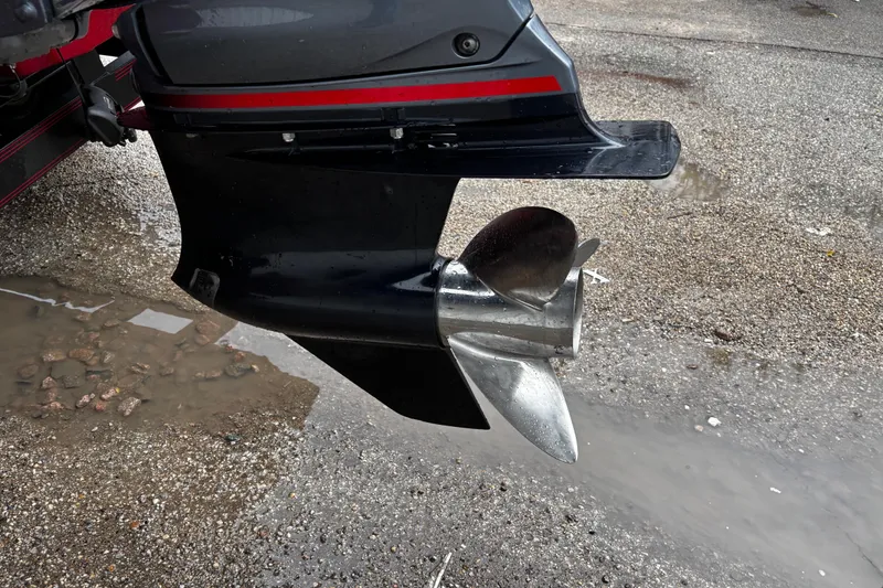 Slide: The Image of Trailer wheels of a 2012 Skeeter ZX200 boat on a wet gravel surface. - 17