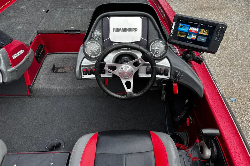 Slide: The Image of Open storage compartment in 2012 Skeeter ZX200 boat, featuring carpeted interior and rod holders. - 20
