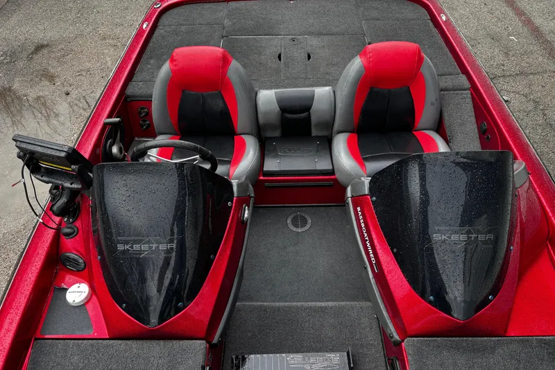 Slide: The Image of 2012 Skeeter ZX200 boat compartment with red interior and measurement guide. - 23
