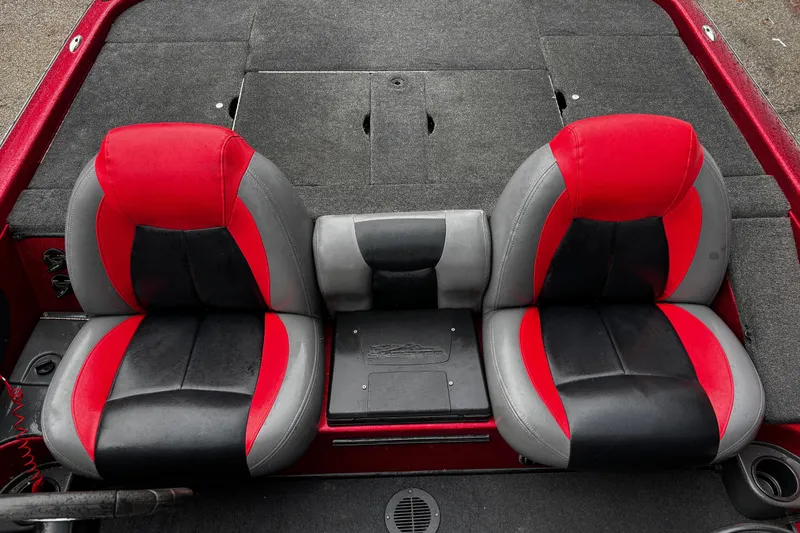 Slide: The Image of 2012 Skeeter ZX200 warning labels and capacity information on red boat interior. - 24