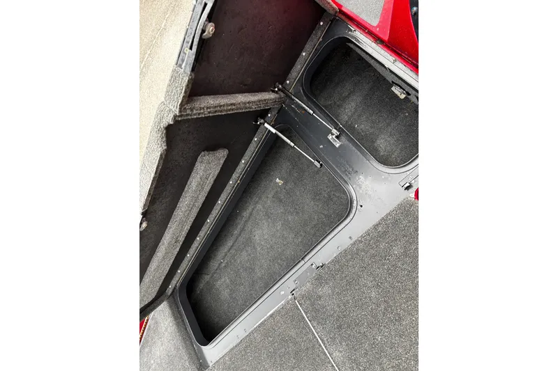 Slide: The Image of 2012 Skeeter ZX200 boat storage compartments with carpeted finish. - 26