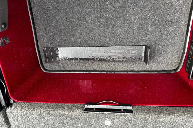 Slide: The Image of 2012 Skeeter ZX200 boat battery compartment with multiple batteries and wiring. - 28