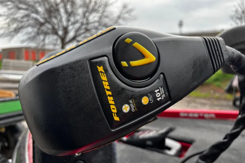 Slide: The Image of 2012 Skeeter ZX200 boat with red and gray interior, parked among other boats. - 38