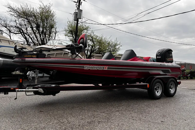 Slide: The Image of 2012 Skeeter ZX200 boat interior with red and gray seats, wet from rain. - 39