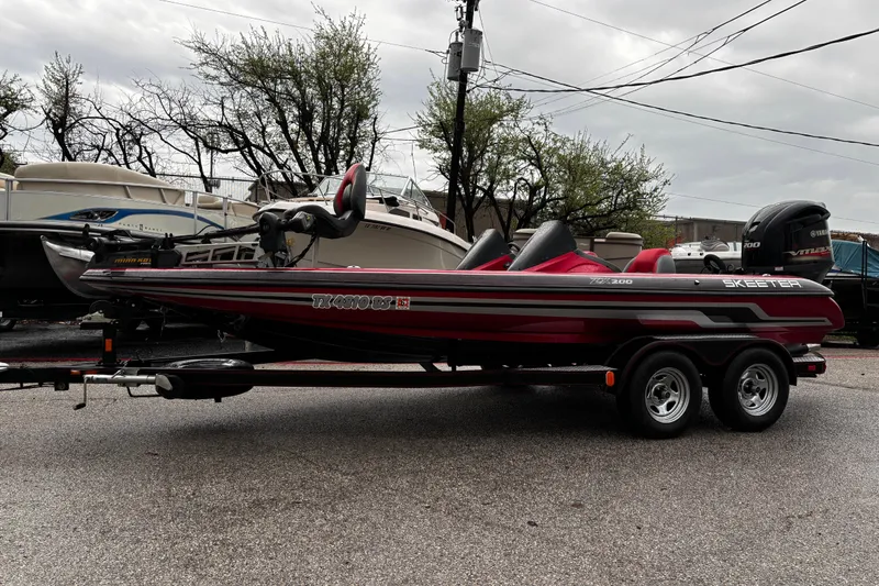 Slide: The Image of 2012 Skeeter ZX200 boat interior with fishing seat and control panel. - 40
