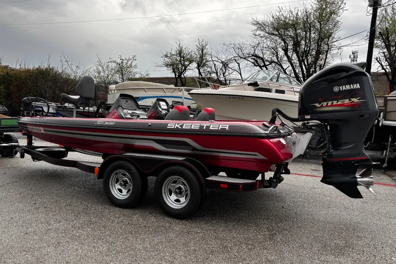 Slide: The Image of 2012 Skeeter ZX200 boat with red and black design on a dual-axle trailer. - 42