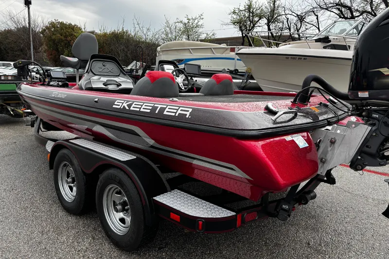 Slide: The Image of 2012 Skeeter ZX200 bass boat on trailer, parked outdoors. - 43