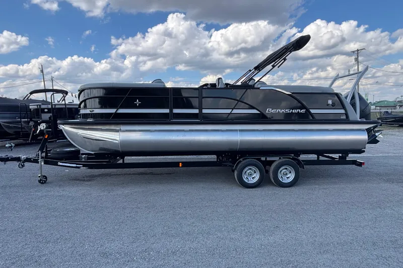 Slide: The Image of 2026 Berkshire 23RFX STS pontoon boat on trailer under a cloudy sky. - 15