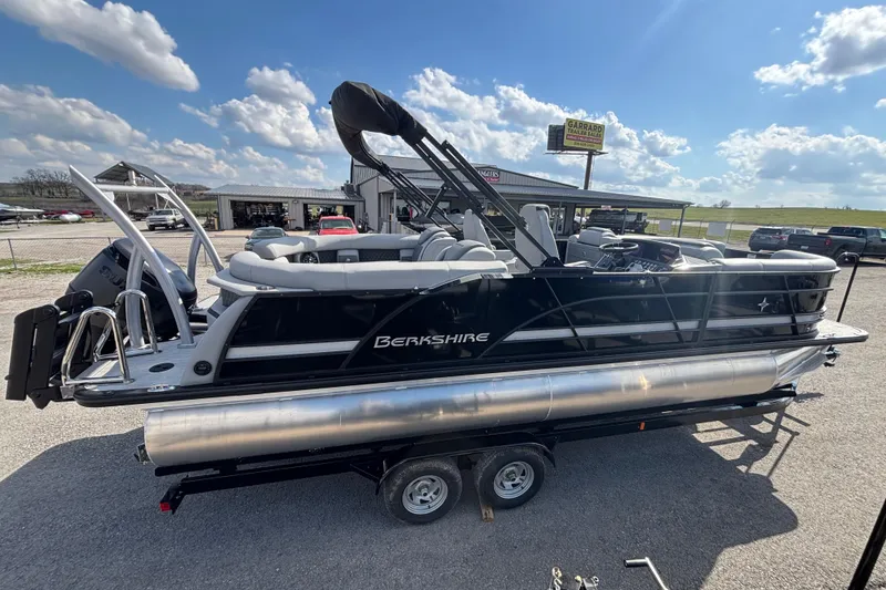 The Image of 2026 Berkshire 23RFX STS pontoon boat on trailer under a clear blue sky. - 4