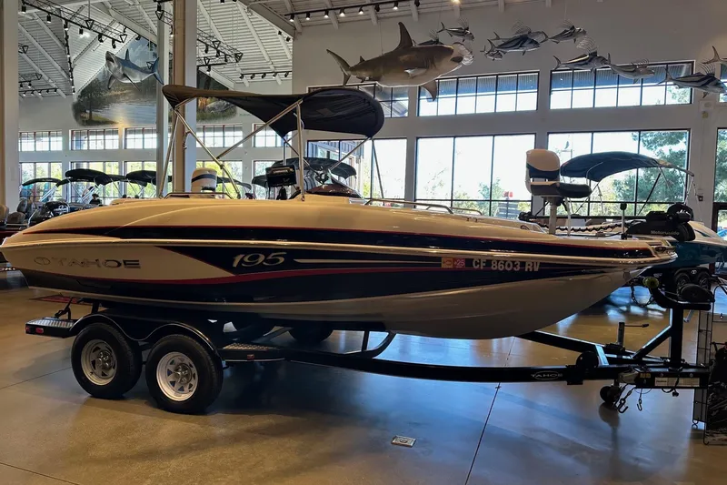 Slide: The Image of 2013 Tahoe 195 I/O boat displayed indoors on a trailer. - 2