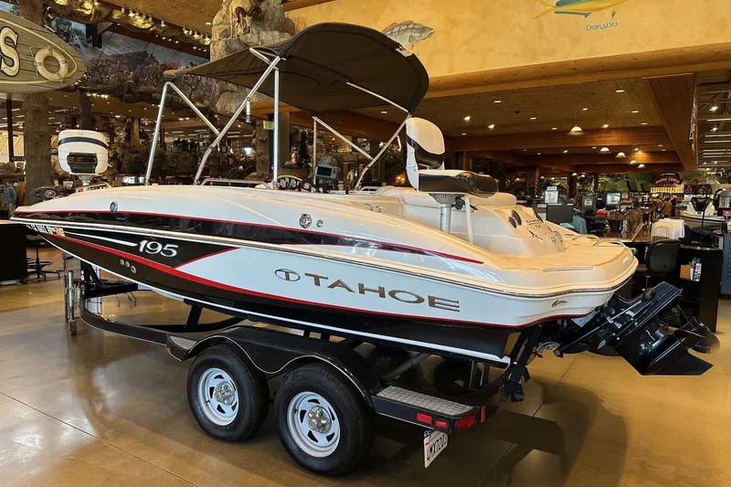Slide: The Image of 2013 Tahoe 195 I/O boat displayed indoors on a trailer. - 3