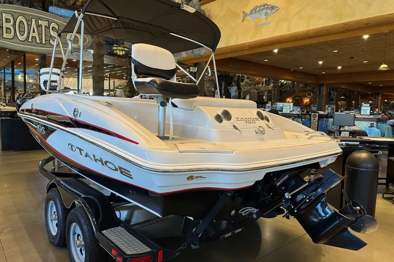 Slide: The Image of 2013 Tahoe 195 I/O boat displayed indoors on a trailer. - 4