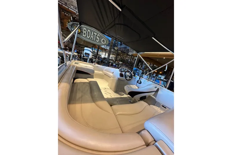 Slide: The Image of 2013 Tahoe 195 I/O boat interior with beige seating and steering wheel. - 5