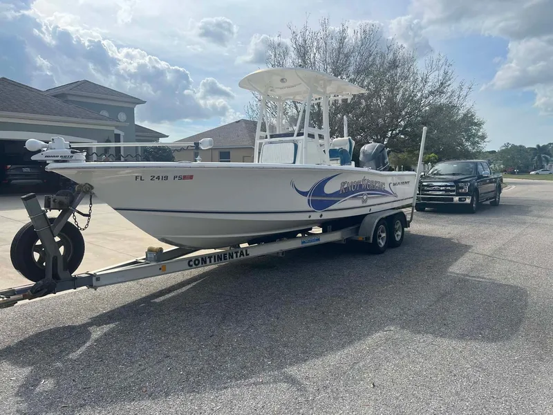 The Image of 2014 Sea Hunt SXS boat on trailer, parked in residential area, sunny day. - 1