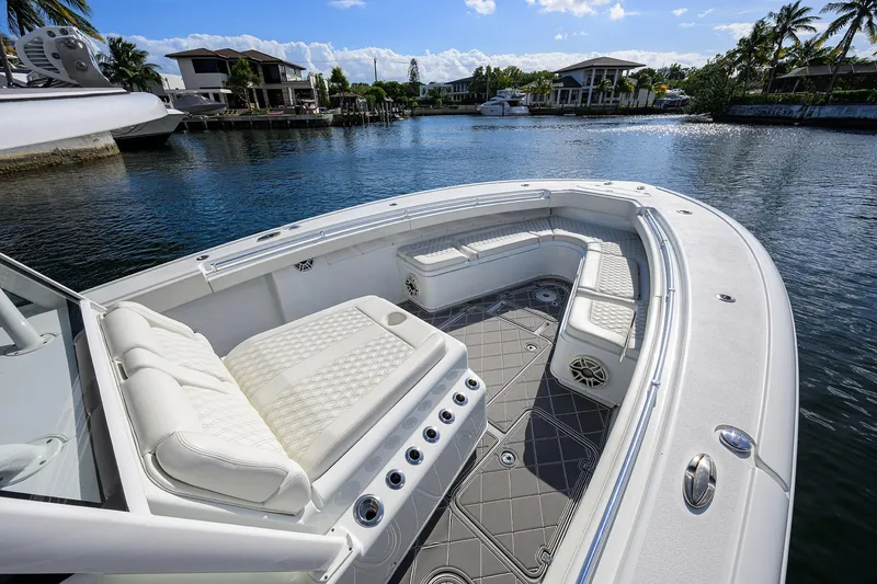 Slide: The Image of 2021 Yellowfin 42 boat with luxurious seating on a calm waterfront. - 15