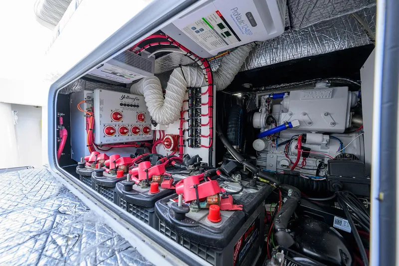 Slide: The Image of Engine compartment of a 2021 Yellowfin 42 boat, showcasing batteries and wiring. - 31