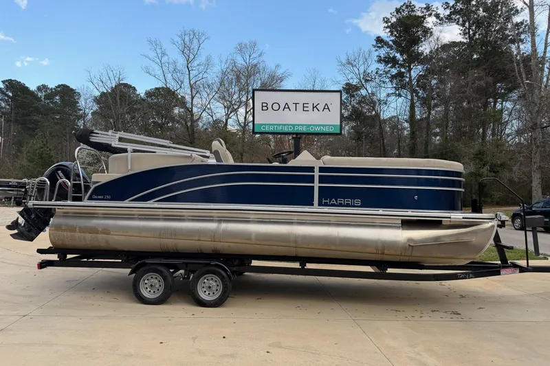 The Image of 2023 Harris Cruiser 230 pontoon boat on trailer at Boateka dealership. - 0