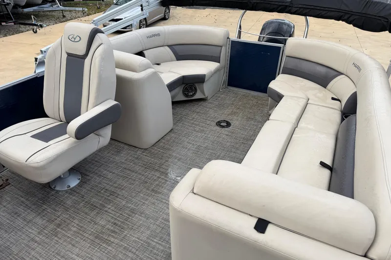 Slide: The Image of 2023 Harris Cruiser 230 pontoon boat interior with beige seating and gray accents. - 7