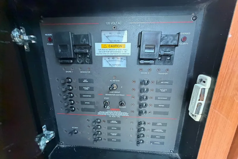 Slide: The Image of Electrical panel of a 2003 Wellcraft 270 Coastal O/B boat with various switches and controls. - 10