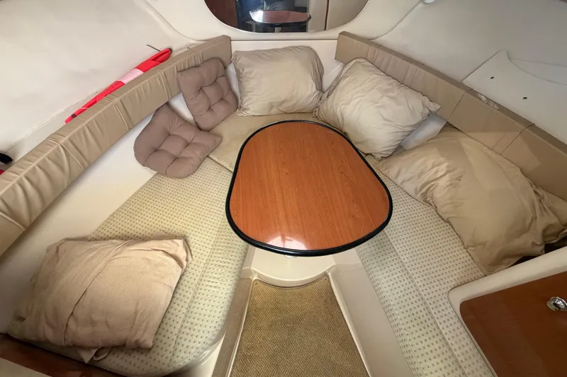 Slide: The Image of Cozy cabin interior of 2003 Wellcraft 270 Coastal O/B with cushions and table. - 12