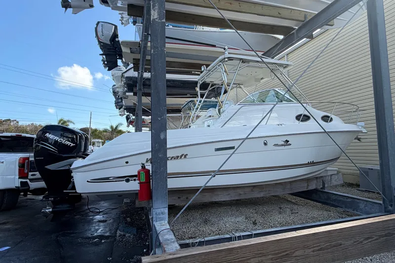 Slide: The Image of 2003 Wellcraft 270 Coastal O/B boat stored on a rack with Mercury outboard engine. - 21