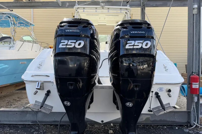 Slide: The Image of 2003 Wellcraft 270 Coastal O/B with twin Verado 250 engines, docked in a marina. - 4