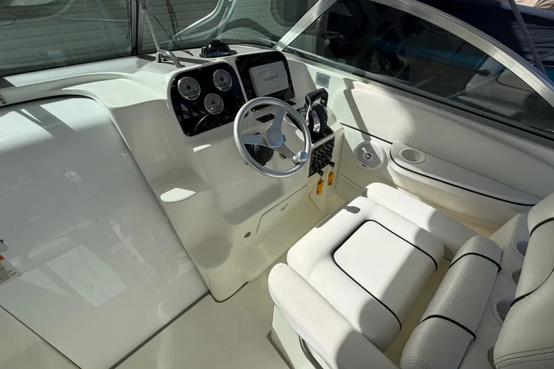 Slide: The Image of 2003 Wellcraft 270 Coastal O/B boat cockpit with steering wheel and control panel. - 5