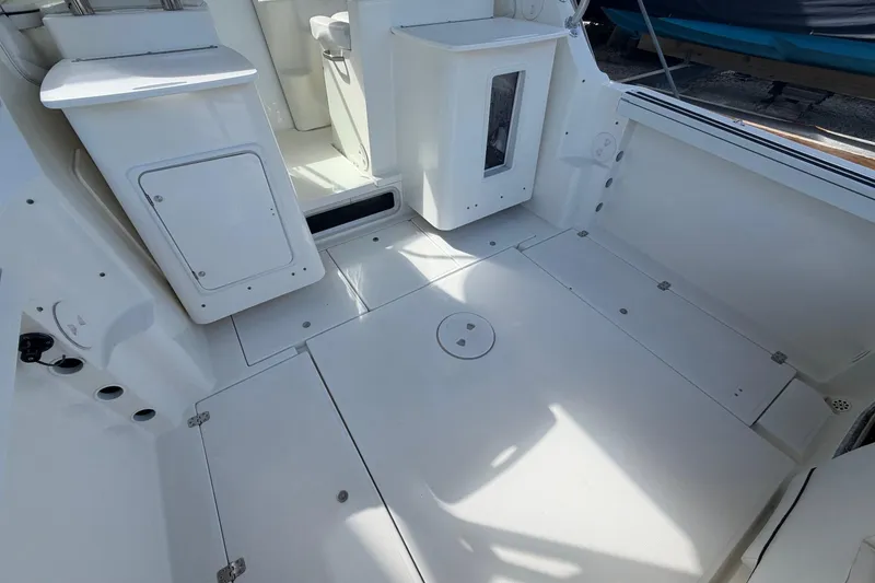 Slide: The Image of 2003 Wellcraft 270 Coastal O/B boat interior with storage compartments and seating. - 8