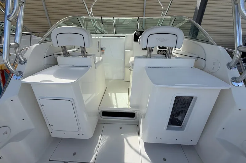 Slide: The Image of 2003 Wellcraft 270 Coastal O/B boat interior with seating and storage compartments. - 9