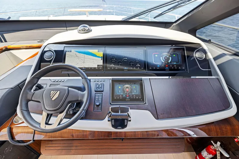 Slide: The Image of Cockpit of 2024 Fairline Squadron 68 yacht with modern navigation displays and steering wheel. - 25