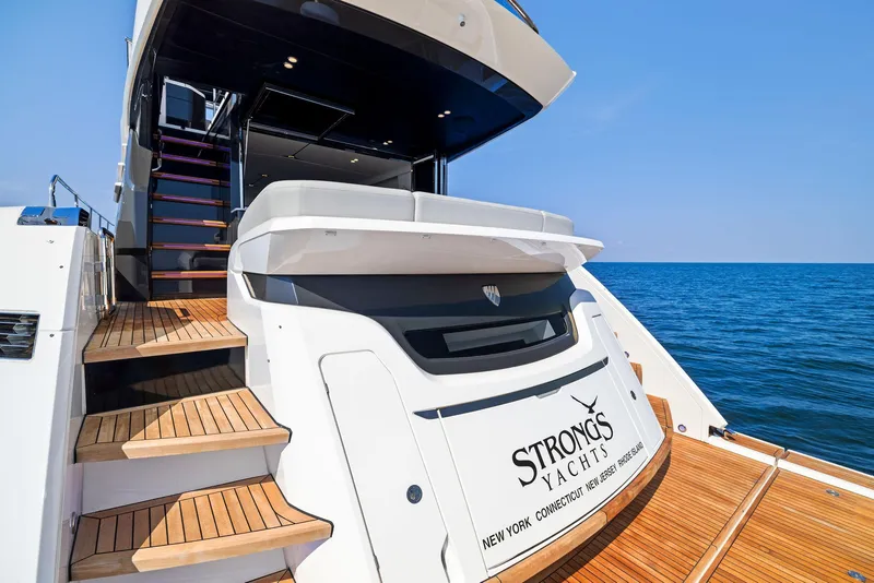 Slide: The Image of 2024 Fairline Squadron 68 yacht with wooden steps, ocean backdrop. - 8