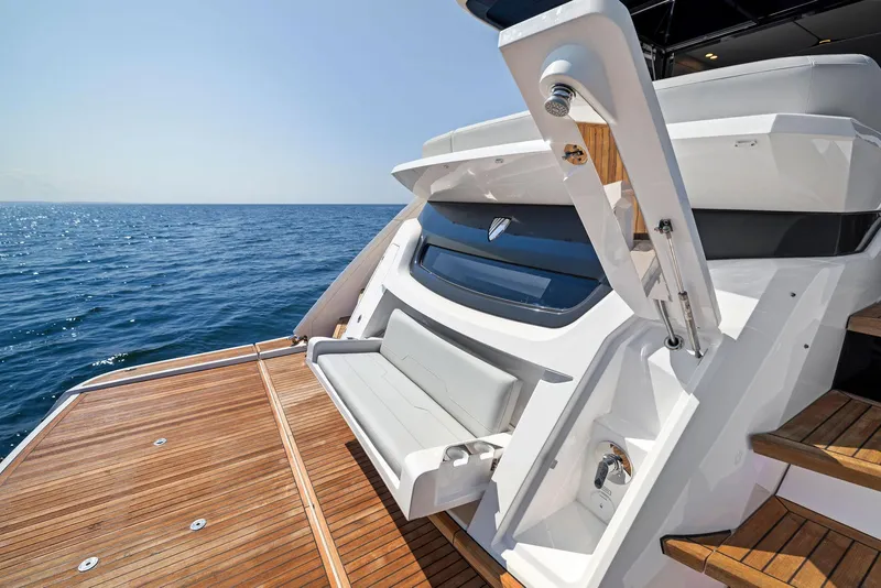 Slide: The Image of Fairline 2024 Squadron 68 yacht with teak deck, ocean view, and luxurious seating. - 9