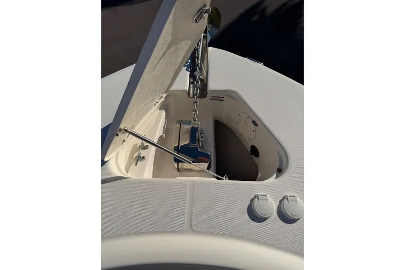 Slide: The Image of 2017 Robalo R302 Center Console anchor compartment with open hatch and chain mechanism. - 10
