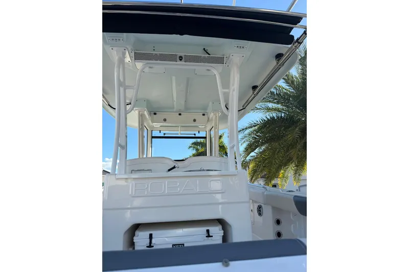 Slide: The Image of 2017 Robalo R302 Center Console boat with T-top, palm trees in background. - 12