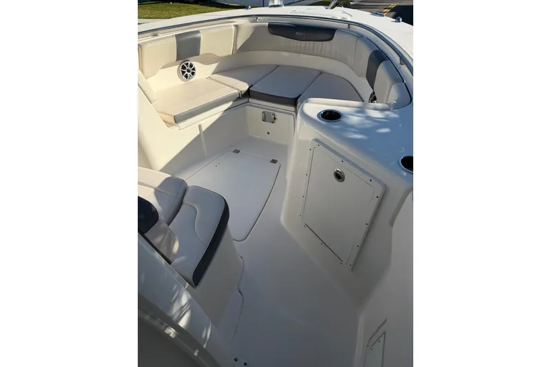 Slide: The Image of 2017 Robalo R302 Center Console boat interior with cushioned seating and storage compartments. - 17