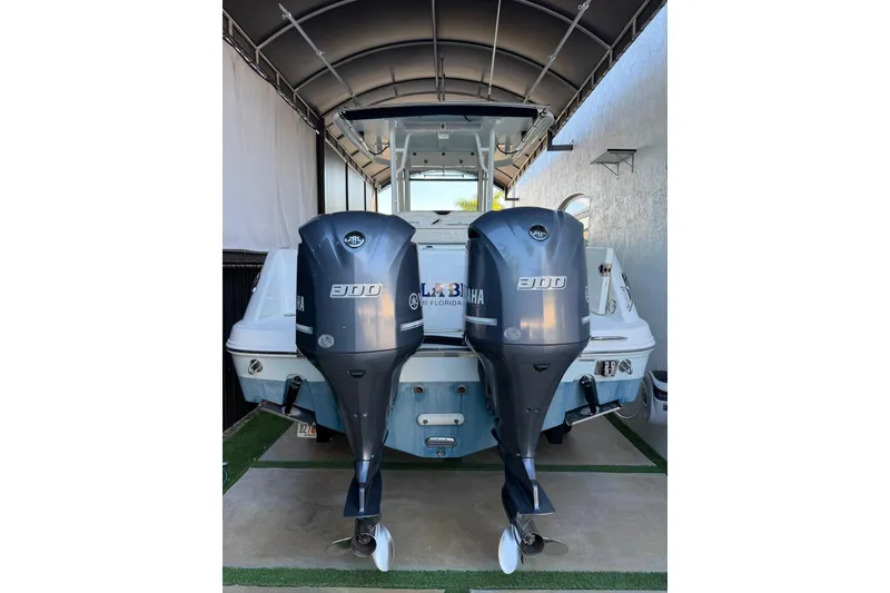 Slide: The Image of 2017 Robalo R302 Center Console with dual Yamaha 300 engines in covered storage. - 4