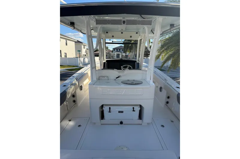 Slide: The Image of 2017 Robalo R302 Center Console boat interior with steering wheel and storage compartments. - 6